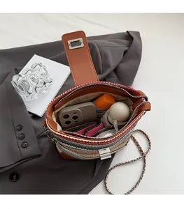 Interior view of colorful straw bucket bag showing storage space for phone and wallet