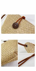 Detail of rainbow woven straw bag featuring round wooden button and brown leather strap