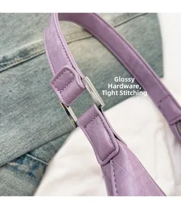 Detail of lavender crescent bag showing glossy hardware and precision stitching