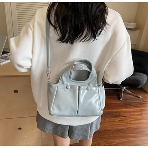 Rear view of a light blue PU leather handbag with shoulder strap for summer fashion