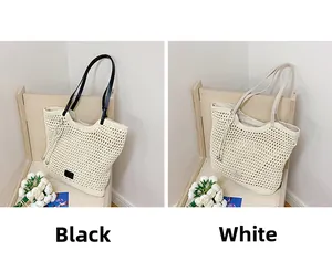 Detail of woven beach tote bags in black and white with honeycomb mesh texture
