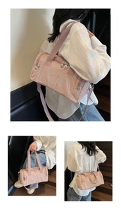 Pink nylon fitness bag with multi-pocket details and adjustable shoulder strap