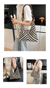 Detail view of woven shoulder bag with black and white floral pattern and wooden bead strap