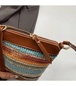 Detailed close-up of a woven straw bucket bag with colorful stripes and a smooth zipper