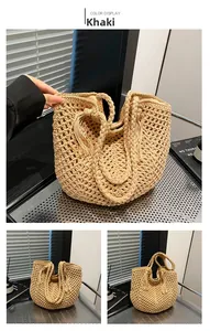 Detail of khaki crochet tote bag featuring intricate openwork patterns and fringe tassel