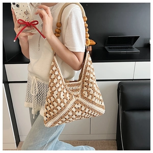 Detail of hand-woven crochet shoulder bag with wood bead strap and geometric pattern