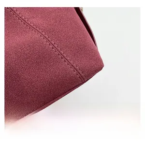 Macro shot of premium burgundy matte texture with fine double stitching craftsmanship