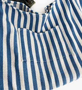 Detailed macro view of blue and white striped tote bag showing woven fabric texture