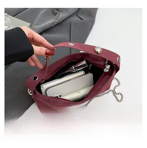 Internal view of burgundy shoulder bag showing space for phone and cosmetics