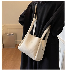 White lychee-textured leather bucket bag featuring a minimalist BAMBOO embossed detail