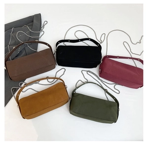 Flat lay of multiple color options for large capacity underarm bags with metal chain straps