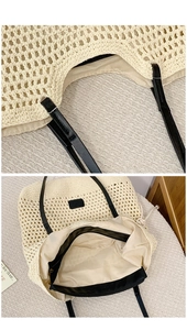 Detail of woven tote bag showing sturdy black leather straps and inner zipper lining