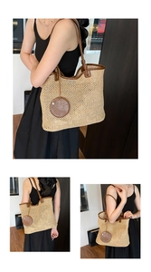 Detail view of a woven straw tote bag featuring brown leather trim and intricate textures