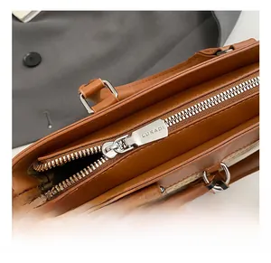 Detailed close-up of brown leather bucket bag featuring premium silver zipper and hardware