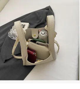Top view of cream bucket bag interior showing spacious capacity for phone and wallet