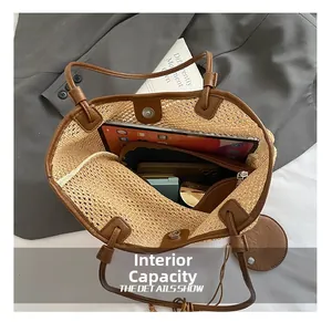 Interior view showing the large capacity and magnetic closure of the woven straw tote bag