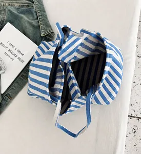 Top view of striped canvas tote showing three internal compartments and large storage space