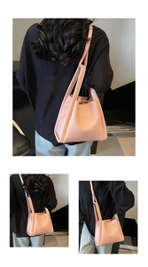 Detailed views of pink lychee leather bucket bag with embossed logo and slender strap