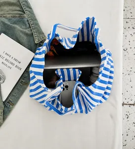 Top view of blue striped tote bag showing spacious interior with laptop and essentials