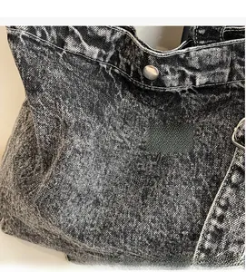 Detailed macro view of retro washed denim fabric texture with silver rivets and stitching