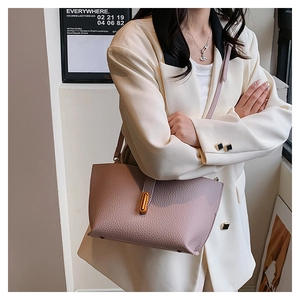 Detail of lavender litchi grain leather tote with elegant golden oval twist lock clasp