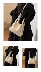 Detailed view of white lychee textured bucket bag with shoulder strap and embossed logo