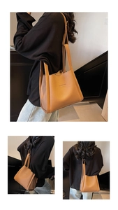 Close-up of brown litchi pattern leather tote bag with BAMROO logo and folded side detail