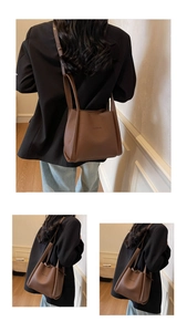 Detailed close-up of brown lychee pattern leather bucket bag with BAMIROO brand logo
