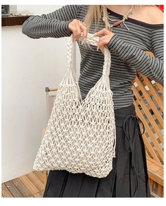 Detail of hand-woven white cotton macramé tote bag with braided handles and inner liner