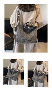 Detail view of large denim tote bag with washed dark gray texture and long shoulder straps