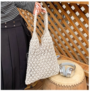 Detail of handcrafted macramé tote bag with woven mesh texture and bohemian handle