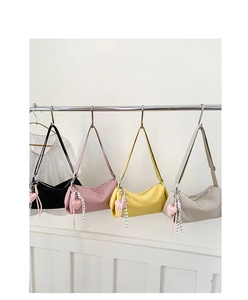Close-up of four nylon hobo bags in black pink yellow and gray with heart charms