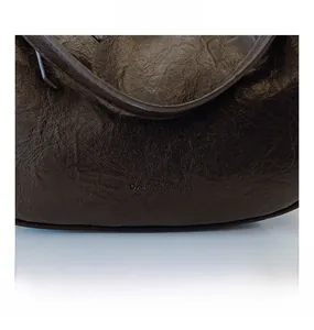 Close-up of textured dark brown leather fabric with embossed brand logo on stylish bag