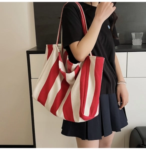 Practical model shot of large red and white striped canvas tote bag for daily commute
