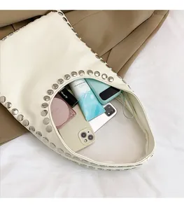 Spacious white hobo bag with silver rivets showing large capacity for daily items
