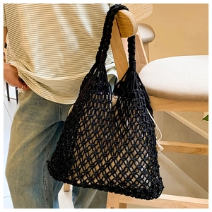 Detail of black woven mesh tote bag with a contrast cream drawstring fabric liner