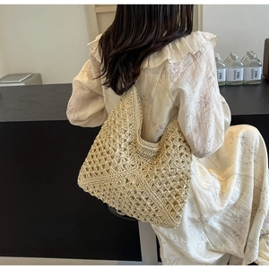 Detailed close-up of ivory crochet tote bag with intricate openwork floral patterns