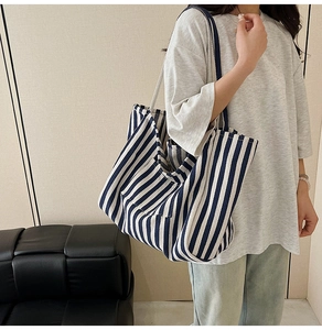Side view of large canvas tote bag with blue and white stripes for daily commuting
