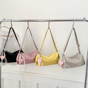 Minimalist nylon crossbody bags in four colors with heart charms and woven straps