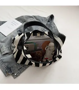Spacious interior of black and white striped woven tote bag with daily essentials