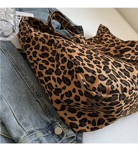 Detail of canvas tote bag with leopard print paired with a blue denim jacket