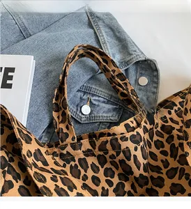 Detail of durable leopard print canvas tote handles with reinforced stitching finish