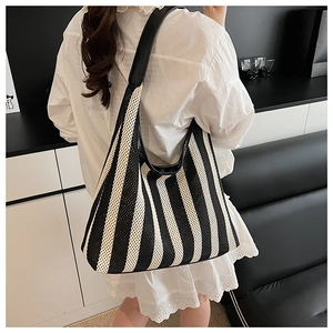 Detail of breathable mesh woven tote bag with black and white vertical stripes
