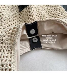 Detail of woven straw bag showing secure zipper closure and magnetic leather fastener