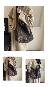 Detail view of large leopard print canvas tote bag with adjustable shoulder strap for women