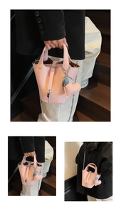 Pink lychee grain bucket bag featuring a belt buckle closure and metal chain strap detail