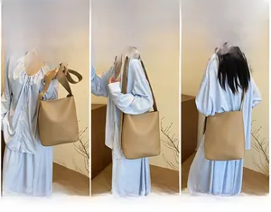 Three-way carry demonstration of vintage khaki bucket bag for crossbody or shoulder use