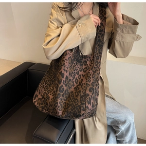 Detailed view of spacious leopard print canvas tote bag with matching wide shoulder strap