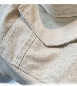 Detail showing high-quality canvas fabric texture and reinforced double-stitching on side pocket