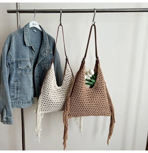 Detailed close-up of bohemian woven tote bags with long tassels and leather straps